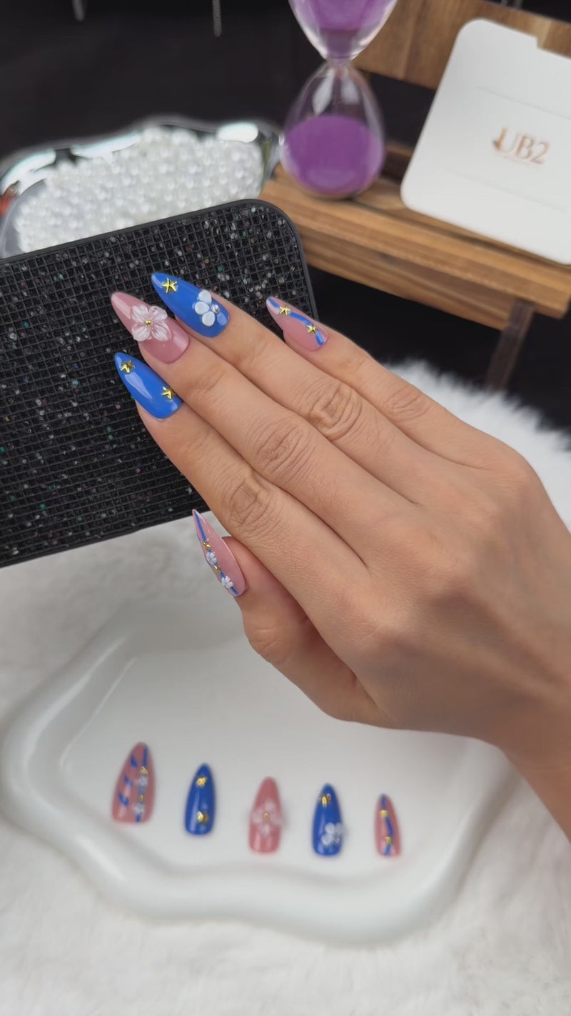 Step-by-step application of Blue Starlight cobalt blue and pink floral star almond press-on nails