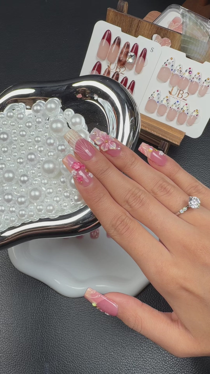 Step-by-step application of Lily Blush pink 3D floral square press-on nails with pearls and gold accents
