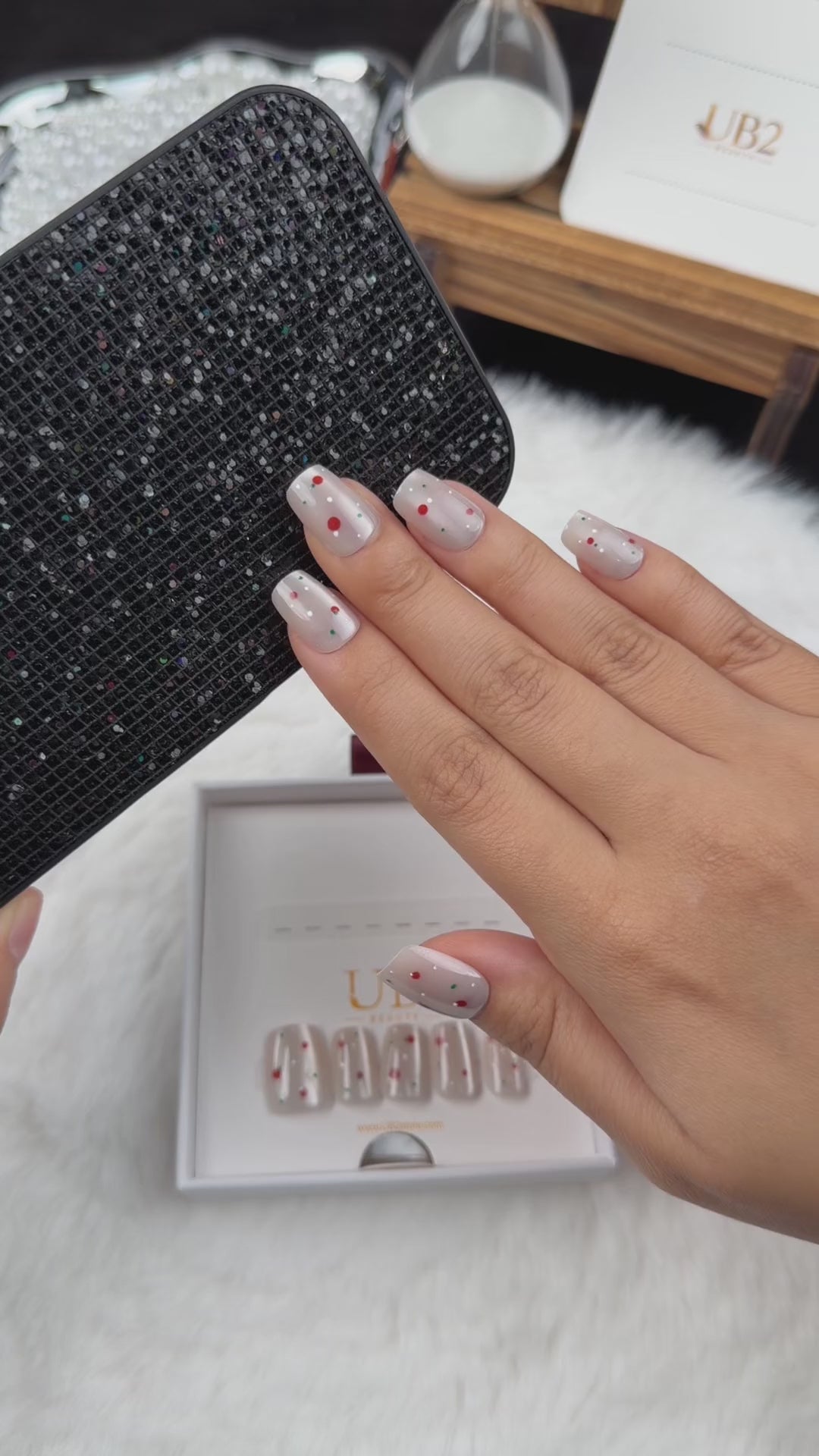 Load video: Step-by-step application of Cherry Pearl pearl white square press-on nails with red cherry accents