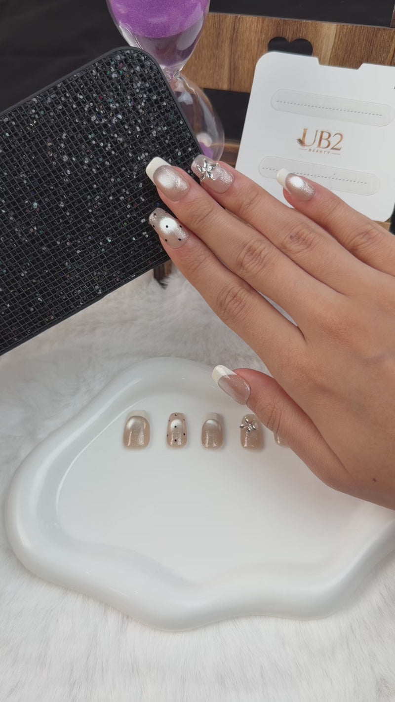 Step-by-step application of Pearl white French tip silver cat eye square press-on nails with floral accents