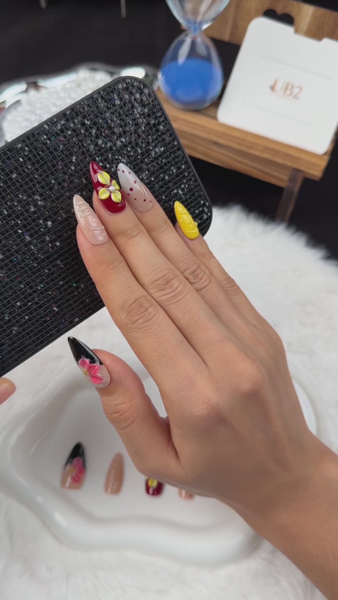 Load video: Step-by-step application of Golden Orchid yellow, burgundy and black floral almond press-on nails