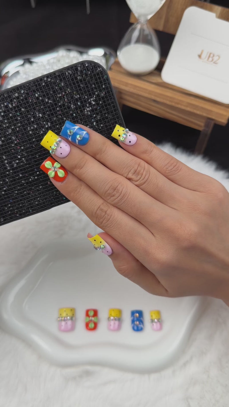 Step-by-step application of Colour Parade yellow, pink and blue floral square press-on nails