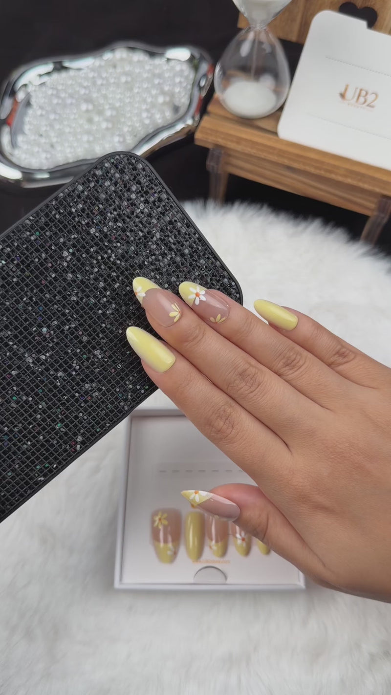 Step-by-step application of Sunshine Daisy yellow French tip daisy almond press-on nails