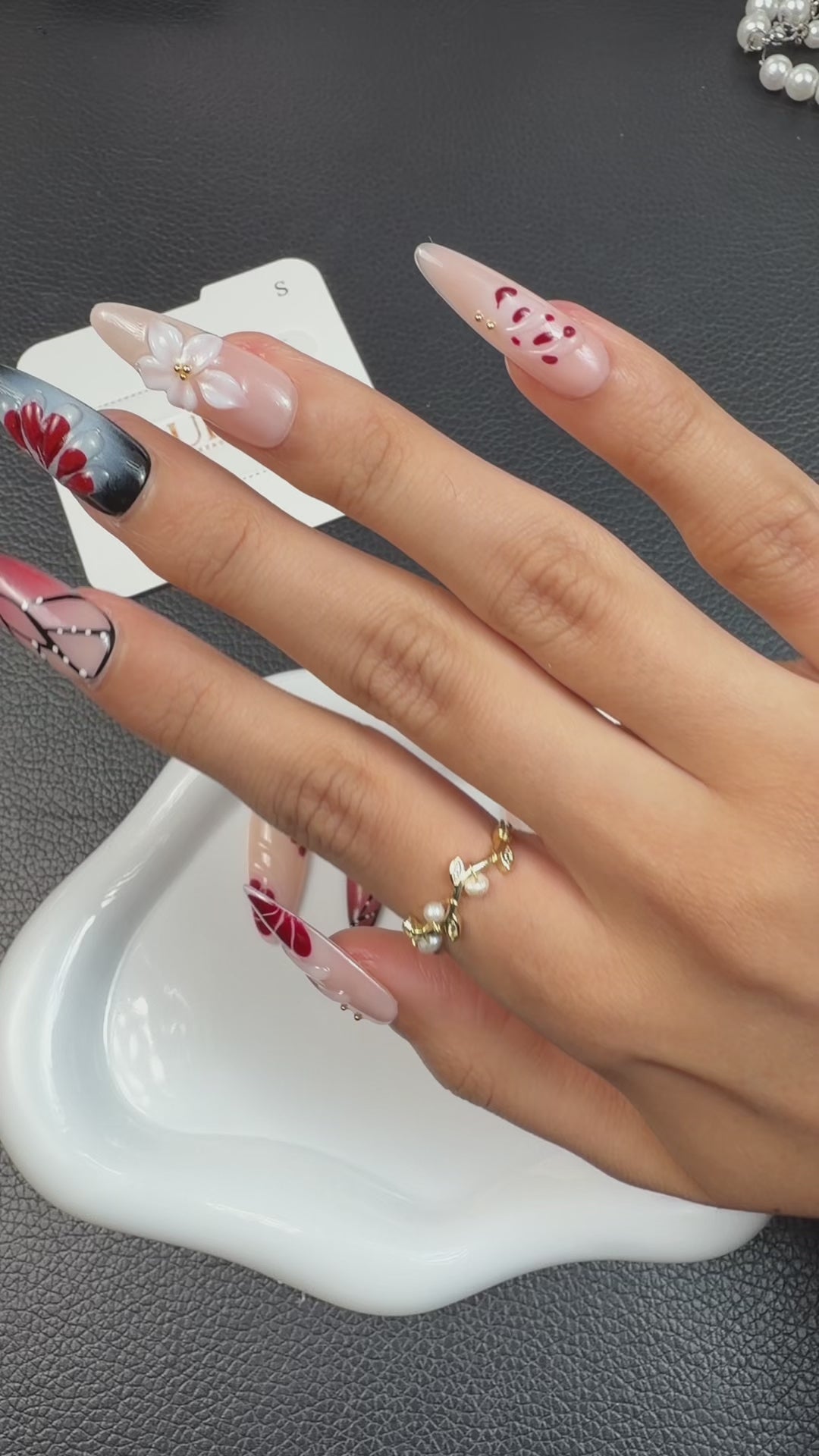 Load video: Trying on Crimson Wings deep red and black butterfly stiletto press-on nails, ending with the UB2 boxed collection