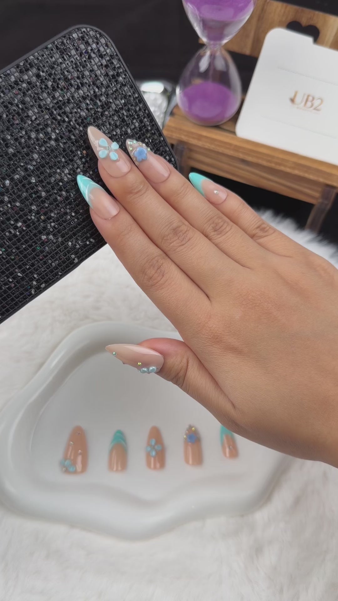 Load video: Step-by-step application of Aqua Blossom turquoise French tip and blue floral almond press-on nails