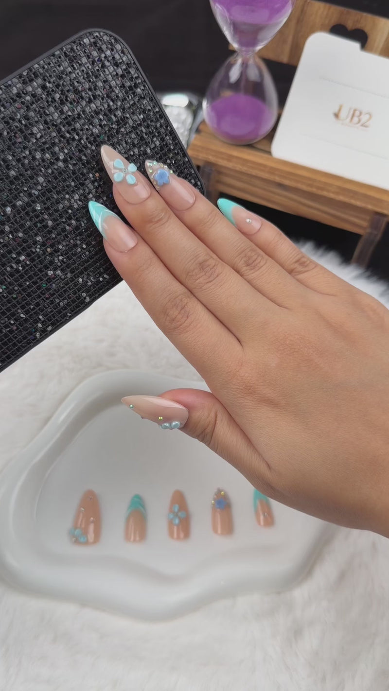 Step-by-step application of Aqua Blossom turquoise French tip and blue floral almond press-on nails
