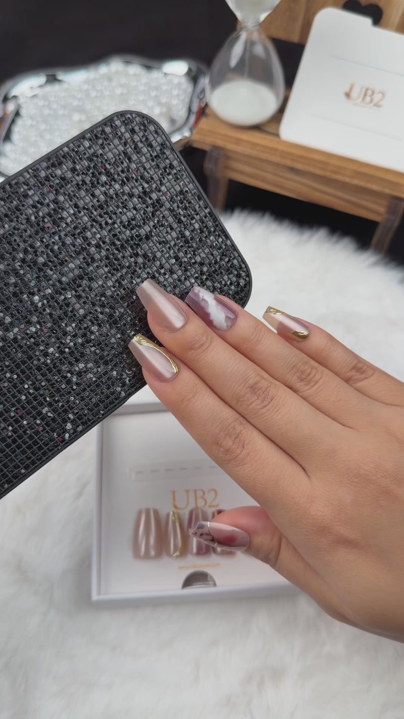 Step-by-step application of Amber Vein rose marble and gold-tone coffin press-on nails