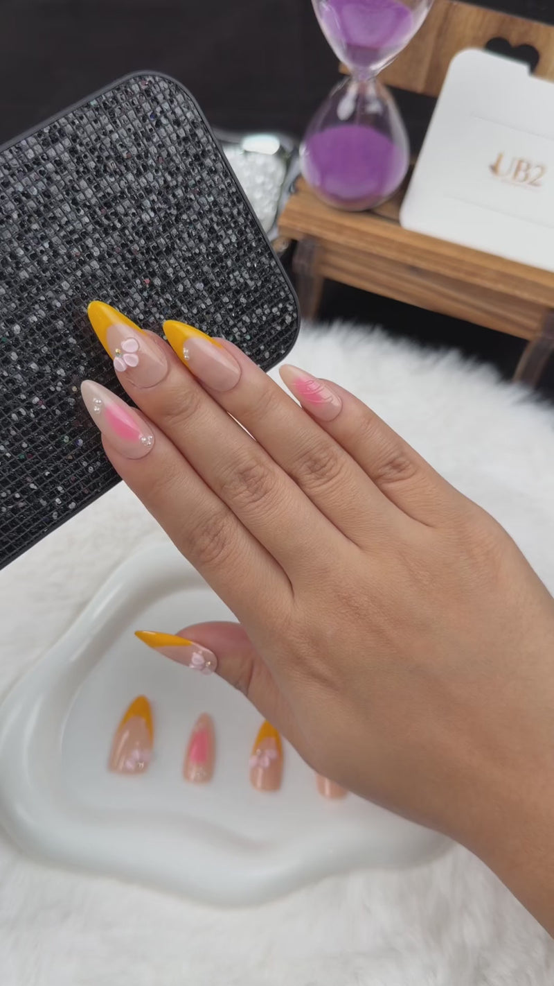 Step-by-step application of Apricot Petals orange French tip and pink floral almond press-on nails