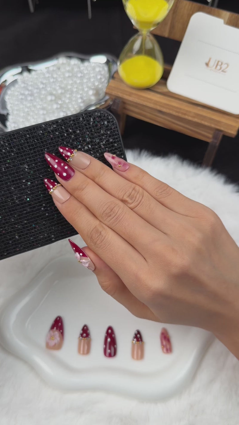 Step-by-step application of Cherry Blossom burgundy polka dot French tip floral almond press-on nails