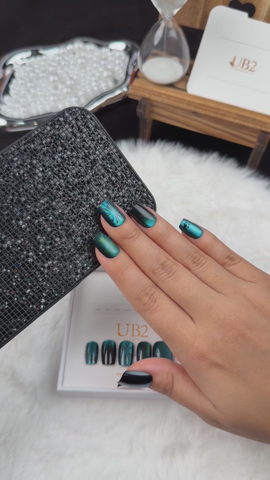 Load video: Step-by-step application of Ocean Afterglow teal and black cat eye square press-on nails