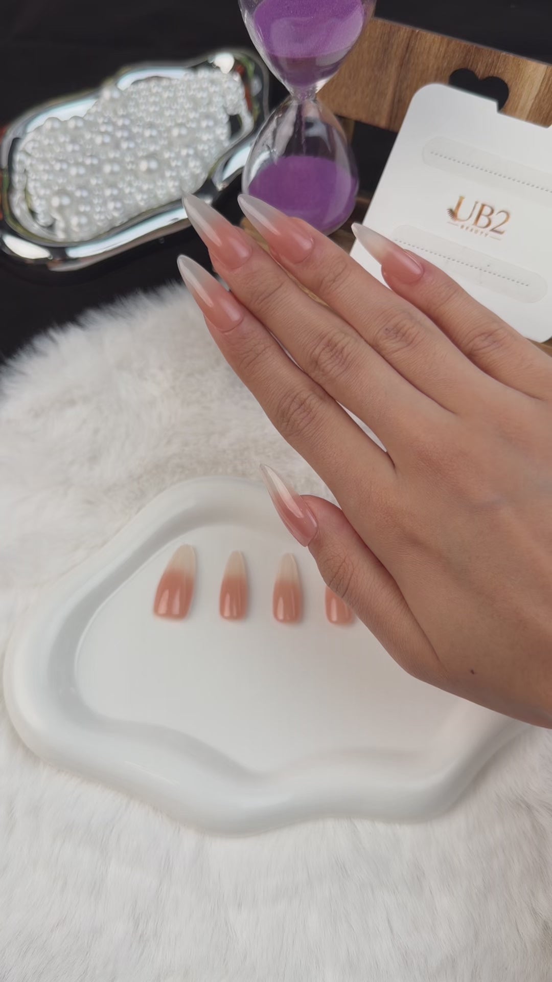 Load video: Step-by-step application of Nude Veil peach nude to grey ombre glossy extra-long oval press-on nails