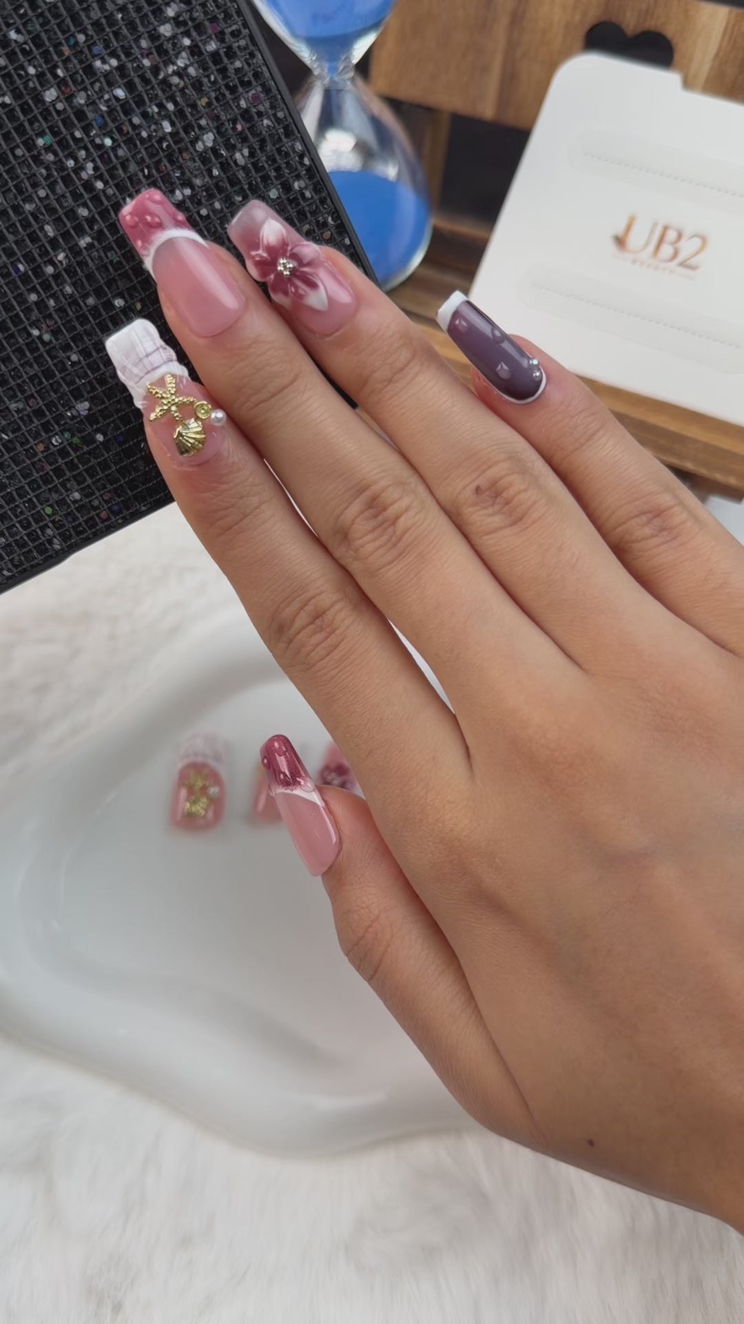 Load video: Step-by-step application of Rose Tide pink, plum and pearl white 3D floral long square press-on nails