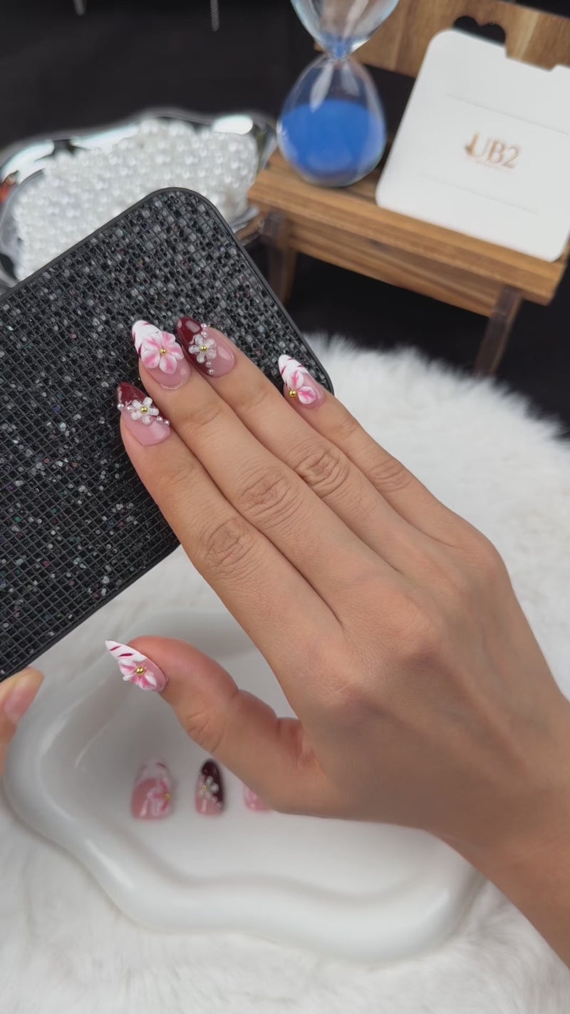 Step-by-step application of Rose Marble pink floral and burgundy French tip almond press-on nails