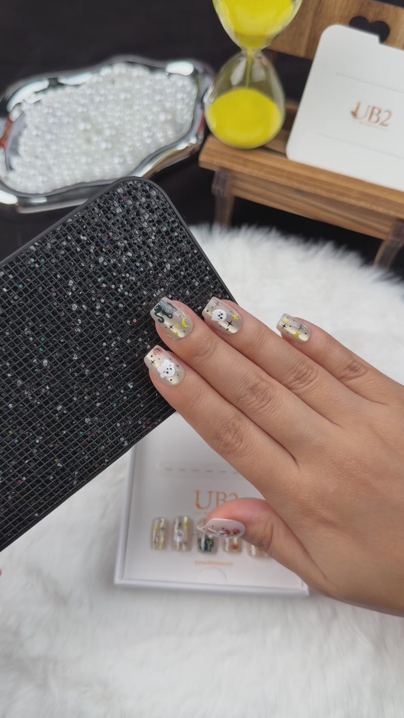 Step-by-step application of Spooky Confetti gold-toned ghost and pumpkin Halloween square press-on nails