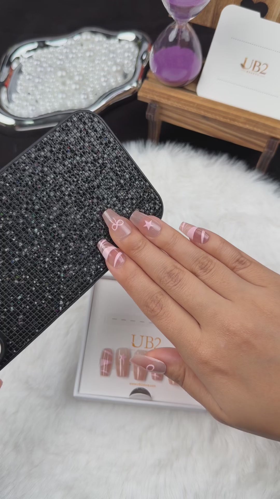 Load video: Step-by-step application of Blush Ribbon nude pink coffin press-on nails with white ribbon and bow designs