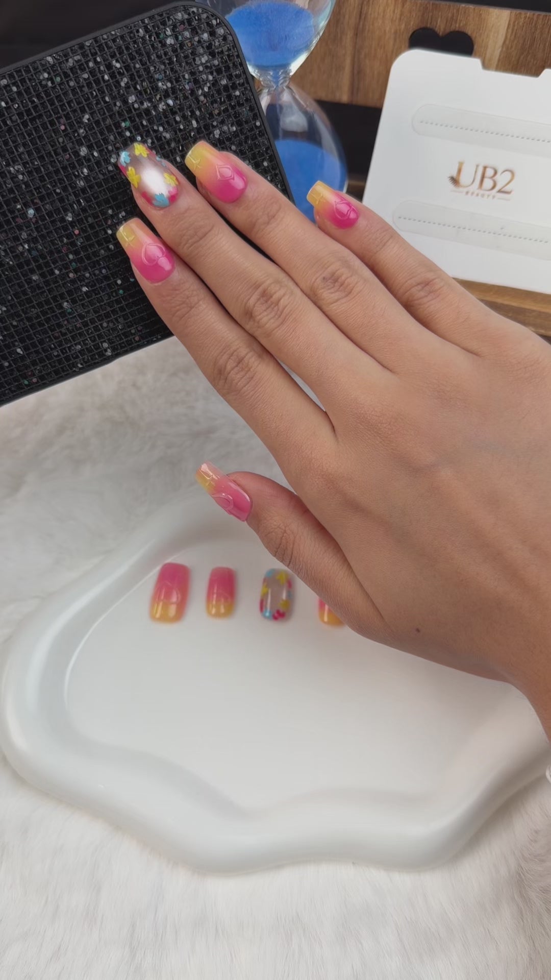 Load video: Step-by-step application of Sunset Pop pink and yellow ombre floral medium square press-on nails