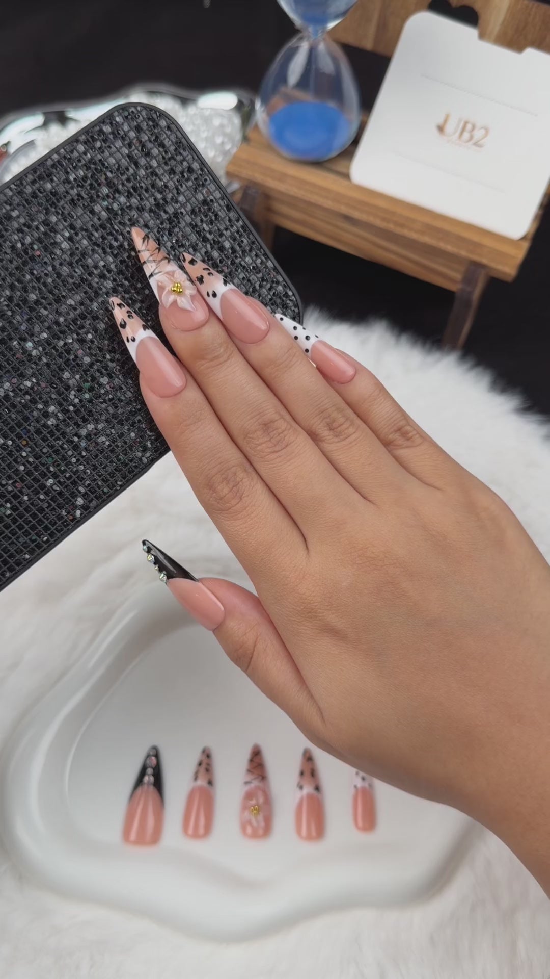 Load video: Step-by-step application of Noir Detail black and nude graphic French tip almond press-on nails