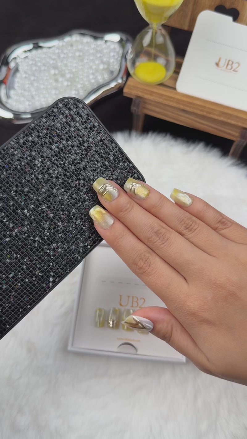 Step-by-step application of Citrine Marble yellow marble square press-on nails with metallic accents