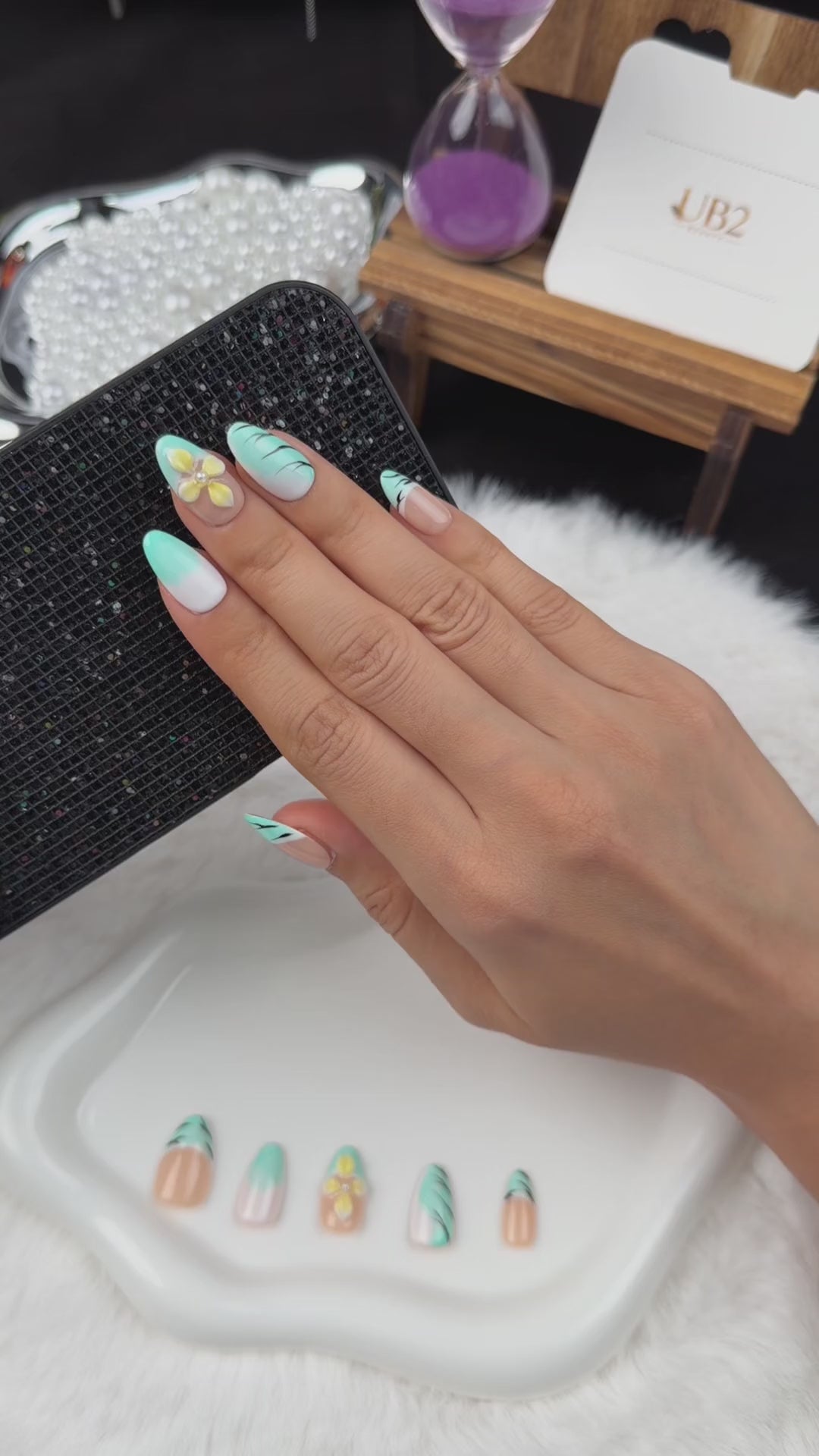 Load video: Step-by-step application of Mint Breeze mint French tip and yellow floral almond press-on nails