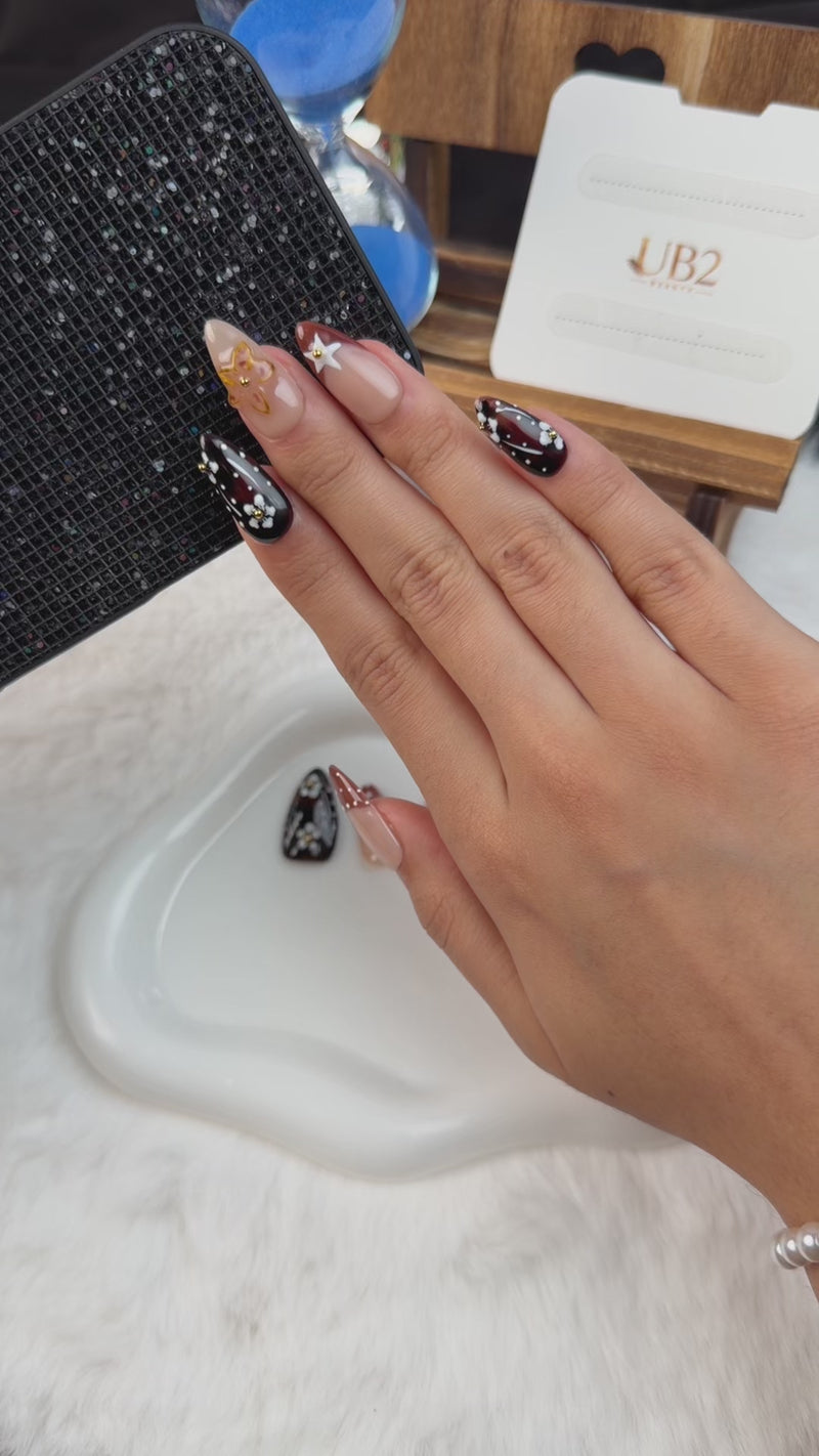 Step-by-step application of Cherry Noir espresso brown and caramel floral almond press-on nails